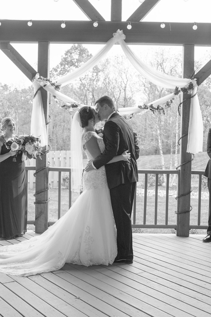 bride and groom share their first kiss during ceremony