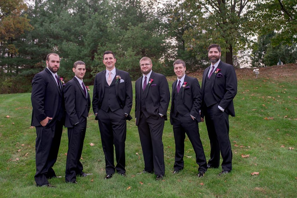 groom and groomsmen stand in yard at the chadwick