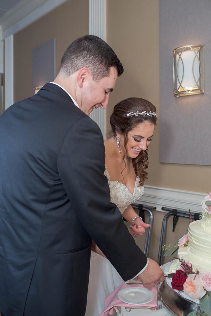 bride and groom cut their cake
