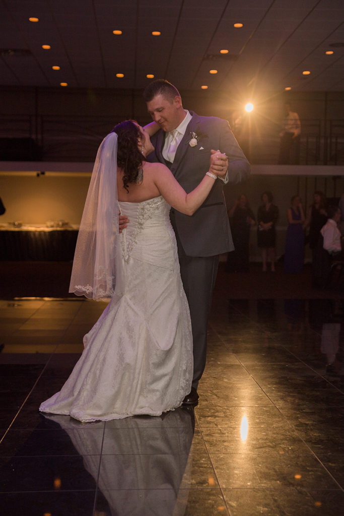 bride and groom smile at each other during their first dance