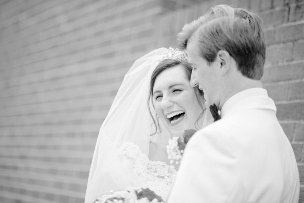 wedding couple embraces and laugh